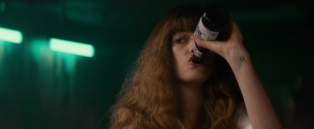 Anne Hathaway drinking a beer in Colossal Movie